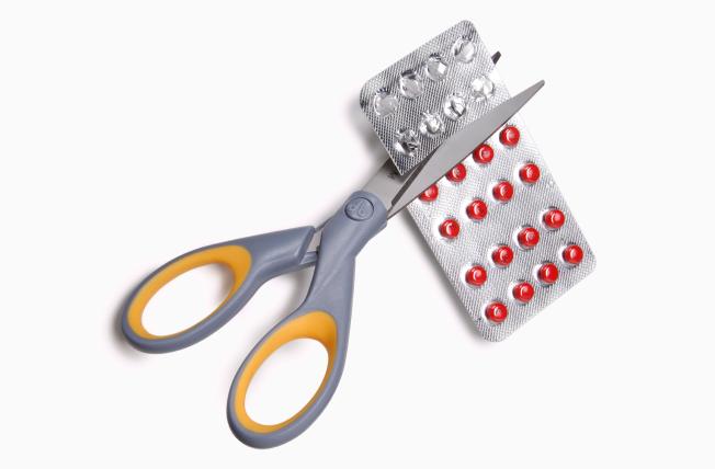Scissors cutting a pill pack