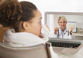 Patient with a cold having a video chat with a health provider from home