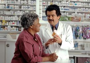 A pharmacist talking to a patient about a medication